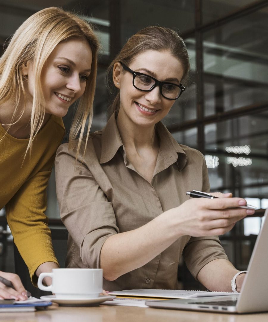 young-smiley-businesswomen-working-with-laptop-desk